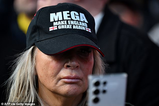 A woman wears a MEGA (Make England Great Again) hat during a vigil for Charlie Kirk at the Montgomery Statue, in Westminster, central London on September 12, 2025