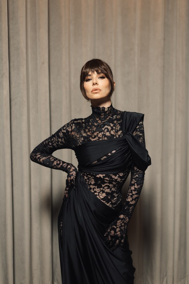 Cheryl Cole in a black lace dress and gloves.