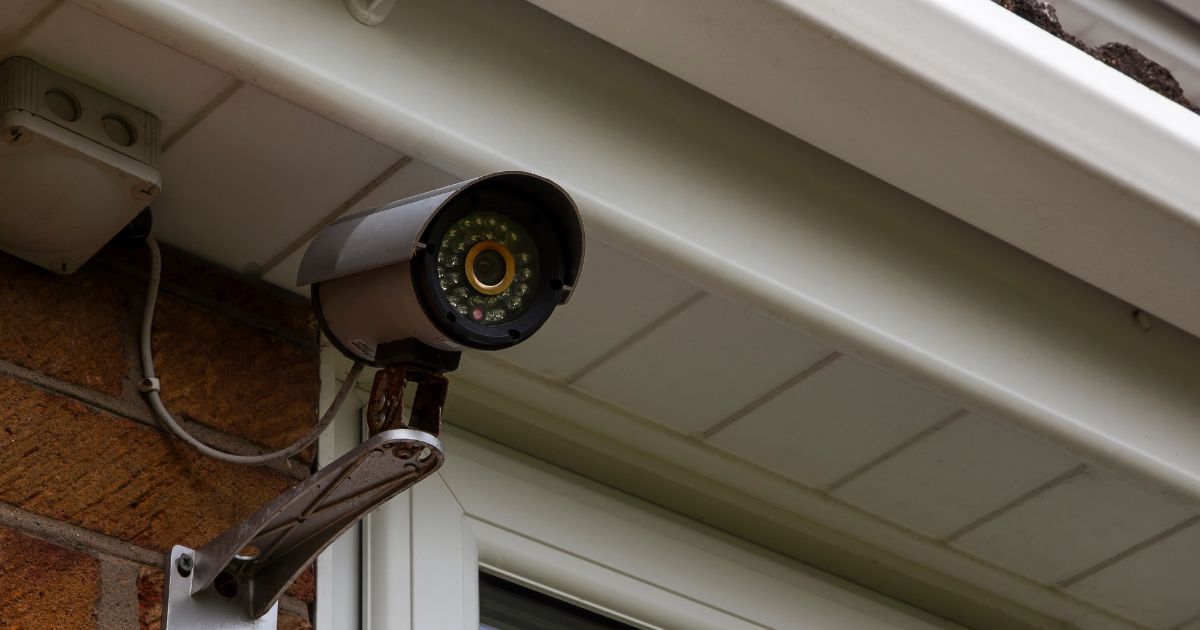 A CCTV camera mounted on house exterior wall.