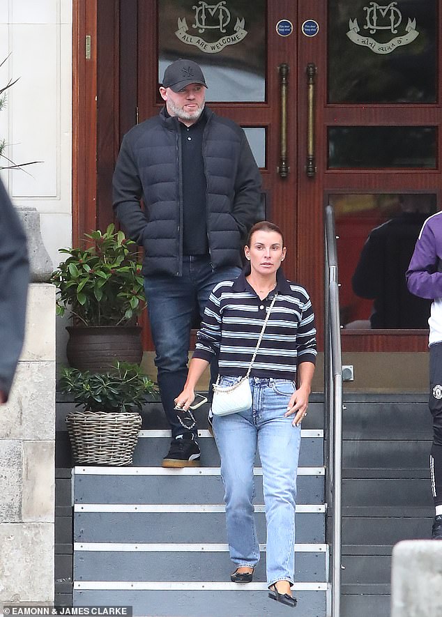 Coleen Rooney was spotted leaving an Indian restaurant with unbuttoned blue jeans with her husband Wayne in Manchester on Tuesday