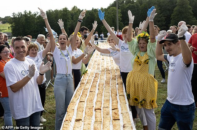 People celebrate after making world's biggest strudel as part of their Guinness World Record attempt, in the village of Jeskovo near Karlovac, Croatia, on September 6, 2025