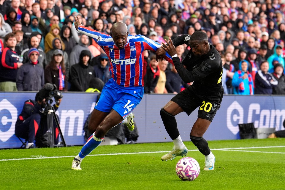 Two soccer players vying for the ball.