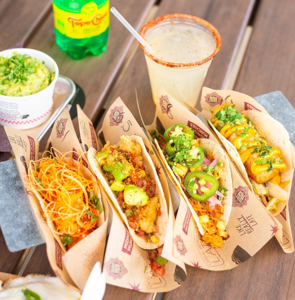 a bottle of schweppes sits next to a table full of food