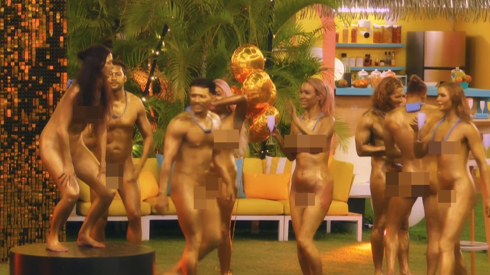Rylan Clark and other individuals covered in gold paint at a "Goldfinger" themed party for the reality TV show "Dating Naked."