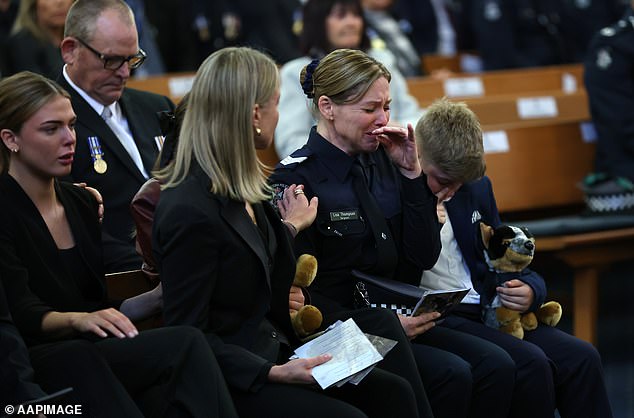 Sergeant Lisa Thompson (R), partner of Neal Thompson, reacts during the funeral service for Detective Leading Senior Constable Neal Thompson at the Victoria Police Academy Chapel in Melbourne, Monday, September 8, 2025. (AAP Image/Con Chronis) NO ARCHIVING, POOL