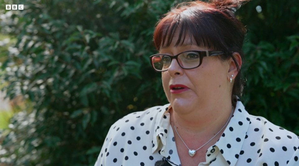 A young woman, Tamzin Hall, wearing a red sweater and a white scarf.