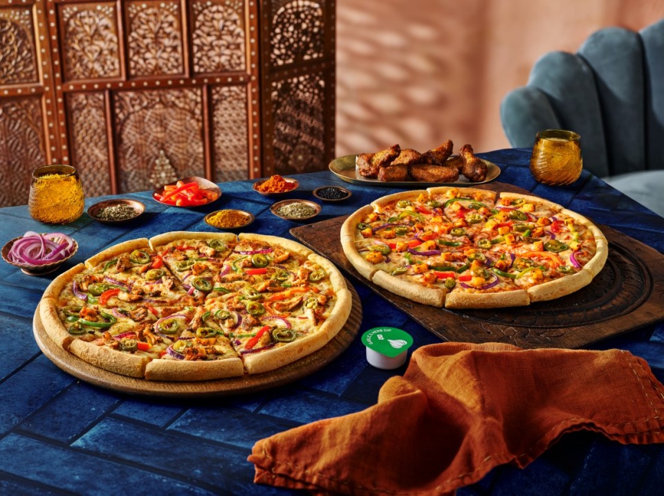 Two Domino's pizzas with chicken and vegetables.