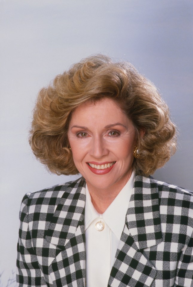 Actress Patricia Crowley smiling, wearing a black and white checkered blazer over a white blouse.