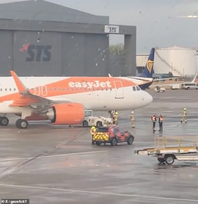 Rescue crews were seen frantically rushing towards an easyJet flight after it was grounded at Manchester Airport following a 'collision' on Saturday