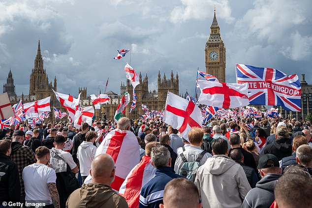 Members of the public cross Westminster Bridge bound for Whitehall during the Unite The Kingdom rally in Central London on Saturday