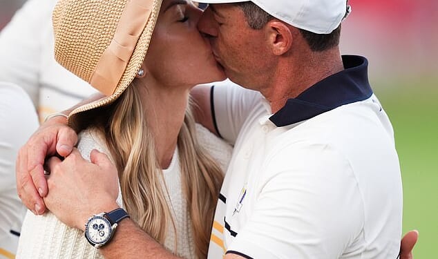 At the end of an emotional week, Rory McIlroy kisses his wife Erica at the Ryder Cup