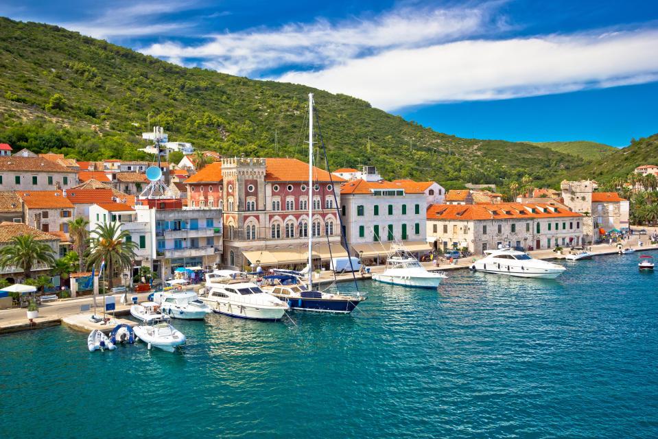 Vis, Croatia harbor with yachts and town buildings.