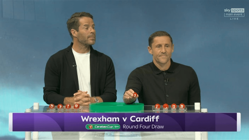 Two men drawing lottery balls for the Carabao Cup Round Four Draw.