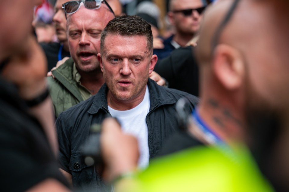 Far-right activist Tommy Robinson (center) at a rally in London.