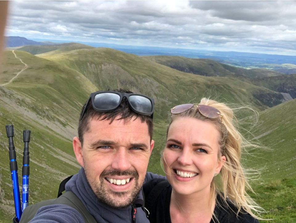 Cherry Turner and Craig Jackson smiling on a mountain.