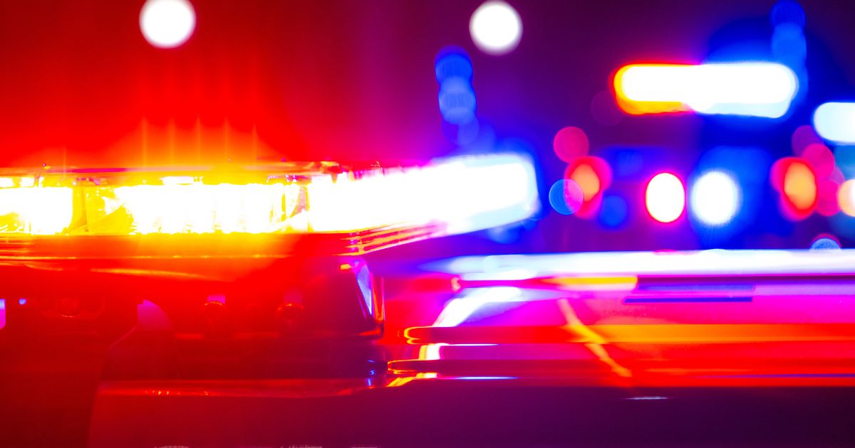 This stock image shows police flashing their lights at a crime scene.