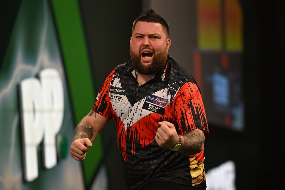 Michael Smith reacts after winning a leg against Kevin Doets at the 2024/25 PDC Paddy Power World Darts Championships.