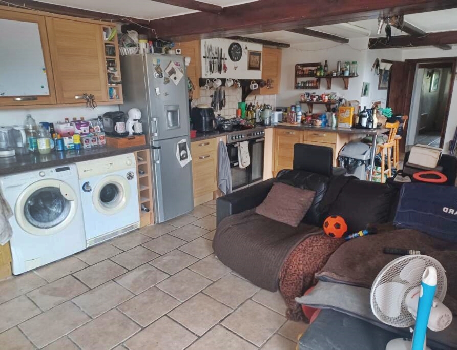 Story from Jam Press (House Listing Feet) Pictured: The interior of the four-bed house on the market for ¿785,000. Toe-tally bizarre! Four-bed house selling for ¿785,000 but pair of bare feet on display A four-bedroom house is selling for ¿785,000 - but a pair of bare feet were spotted on display. The seemingly ordinary cottage was built in the 17th century. The estate agents say the rural property possesses ¿great charm.¿ But something appears to be afoot in one of the snaps. Someone is sitting on the sofa in the lounge. And their tootsies are on show next to two bottles of beer. The pad also has a Tiki bar and a hot tub outside. It also comes with a portacabin being used as a vet's and space for grazing. The house is located in Wimborne, Dorset. The owner is selling up as they¿re planning to emigrate abroad. It¿s being sold by Purple Bricks and advertised on Rightmove, as reported by Luxury Property News. The listing reads: ¿Amazing and rare, affordable opportunity in this popular area. ¿Located in a very popular rural village, with schools and about two miles from Upton Beach. ¿Only a few properties have this amazing access. ¿Freehold four-bedroom cottage, with great charm and original 17th century, with extended and no Grade II Listing now. ¿Large garage with inspection pit. ¿Stable block with tack room. ¿A total of four to eight acres of grazing. Two portacabins are used as a vet surgery and pet grooming parlour. ¿Off-road parking and standing for a horse box by the garage, and even a Tiki Bar. ¿Security cameras all around, lovely neighbours and a country pub over the road. ¿Easy access to Poole and Wimborne - five mins on A31 or A35, Bournemouth - 15 to 20mins. ¿Great local facilities in the area, schools, bus and train. The Jurassic coast is gorgeous, a fab area. ¿Selling up to retire overseas, but very sad to leave this wonderful location." ENDS