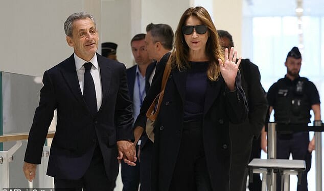 Sarkozy (pictured, left), accompanied by his wife, the singer and model Carla Bruni-Sarkozy (pictured, right), entered into a courtroom filled with reporters and members of the public