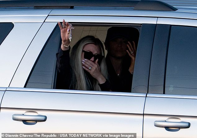 Erika Kirk waved to the supporters from an SUV on Thursday evening, fighting back tears and holding a rosary in her hand, as her husband's remains were taken to an Arizona chapel