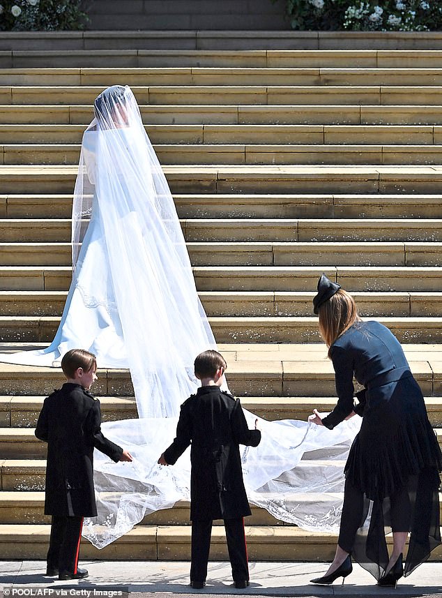 Clare adjusting Meghan’s 16-foot train, May 2018. She was commissioned to design the gown while Creative Director of Givenchy