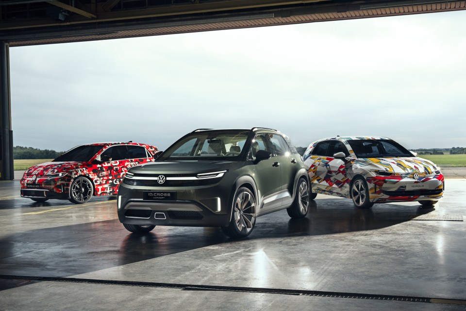 Three Volkswagen concept cars in a hangar.