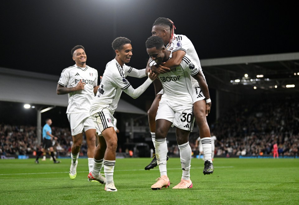 Ryan Sessegnon of Fulham celebrates with teammates Joshua King and Alex Iwobi after the team's third goal.