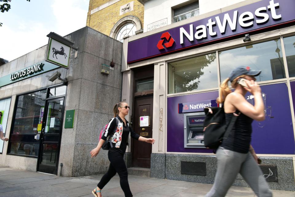 People walking past NatWest and Lloyds Bank branches in Notting Hill, London.