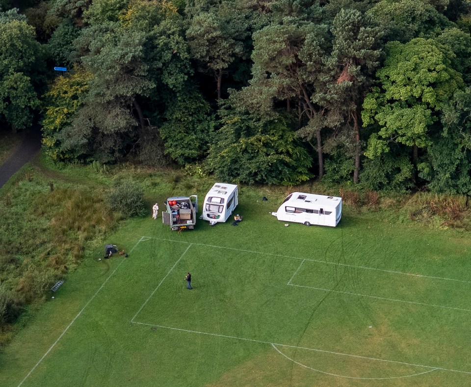 Aerial view of caravans parked on a football pitch.
