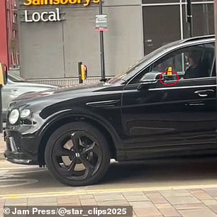 The former Manchester United star was caught holding the device as he drove through Salford