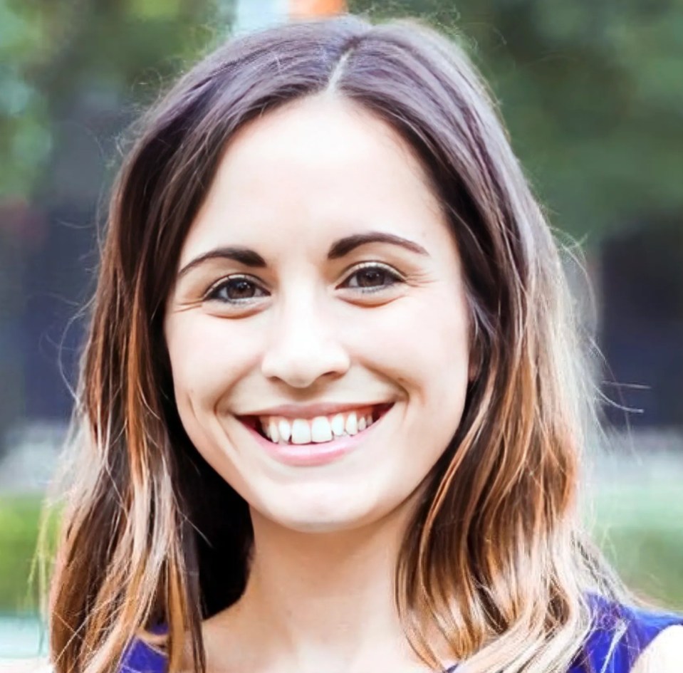 Portrait of Leanne Lucas, a smiling woman with long brown hair, the hero dance and yoga teacher.