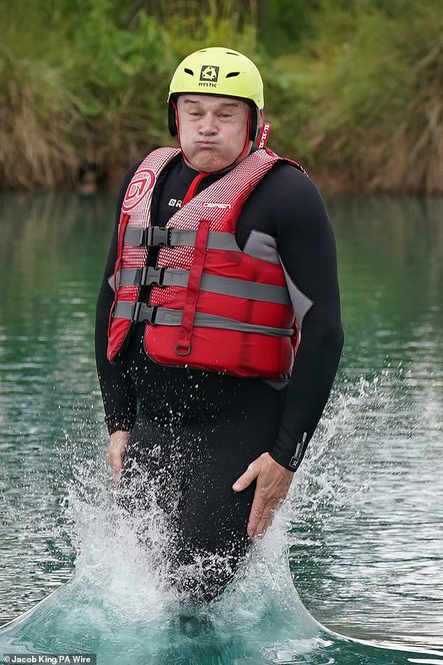 Sir Ed Davey has long been known for his quirky stunts, and is pictured here wearing a wetsuit last June