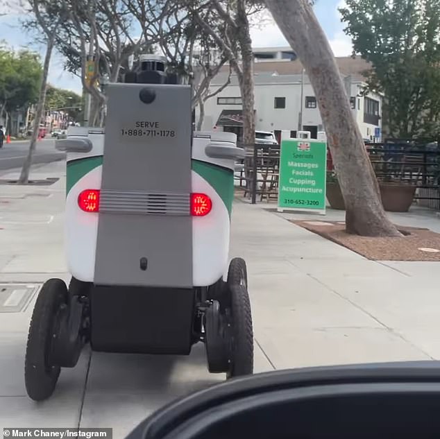 Mark Chaney tried to avoid the robot service cart twice, but it stopped and slammed into his scooter