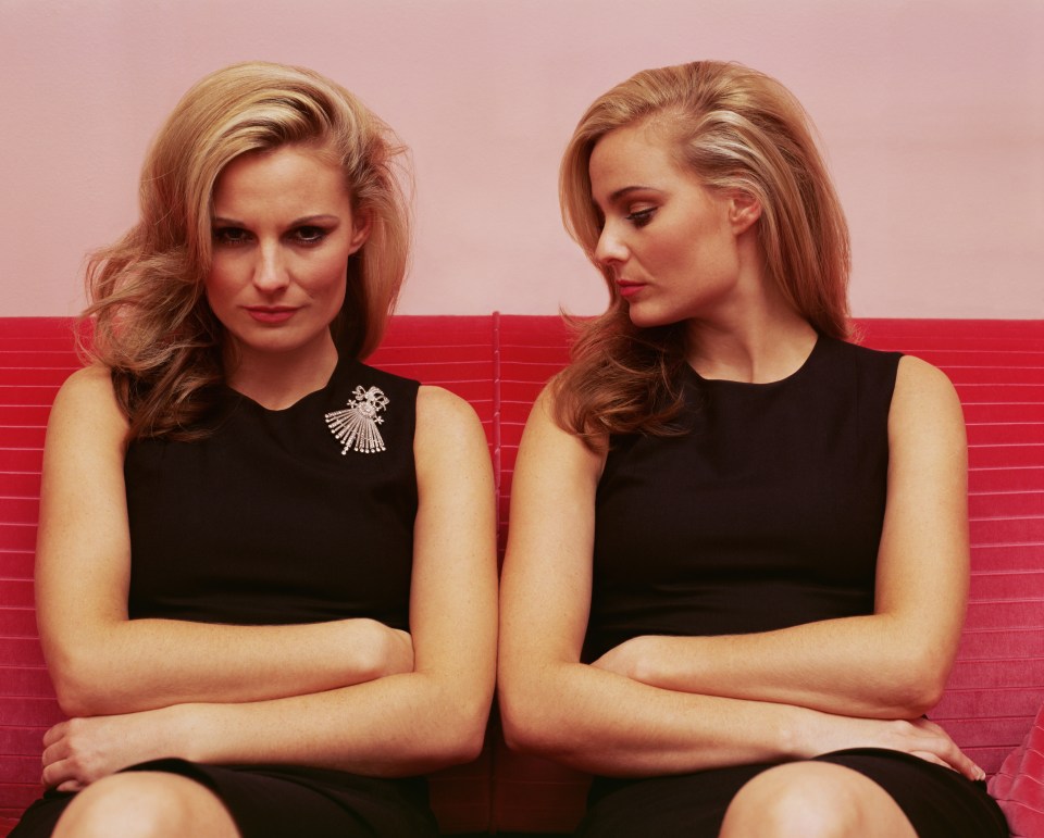 Woman looking jealously at another woman's brooch.