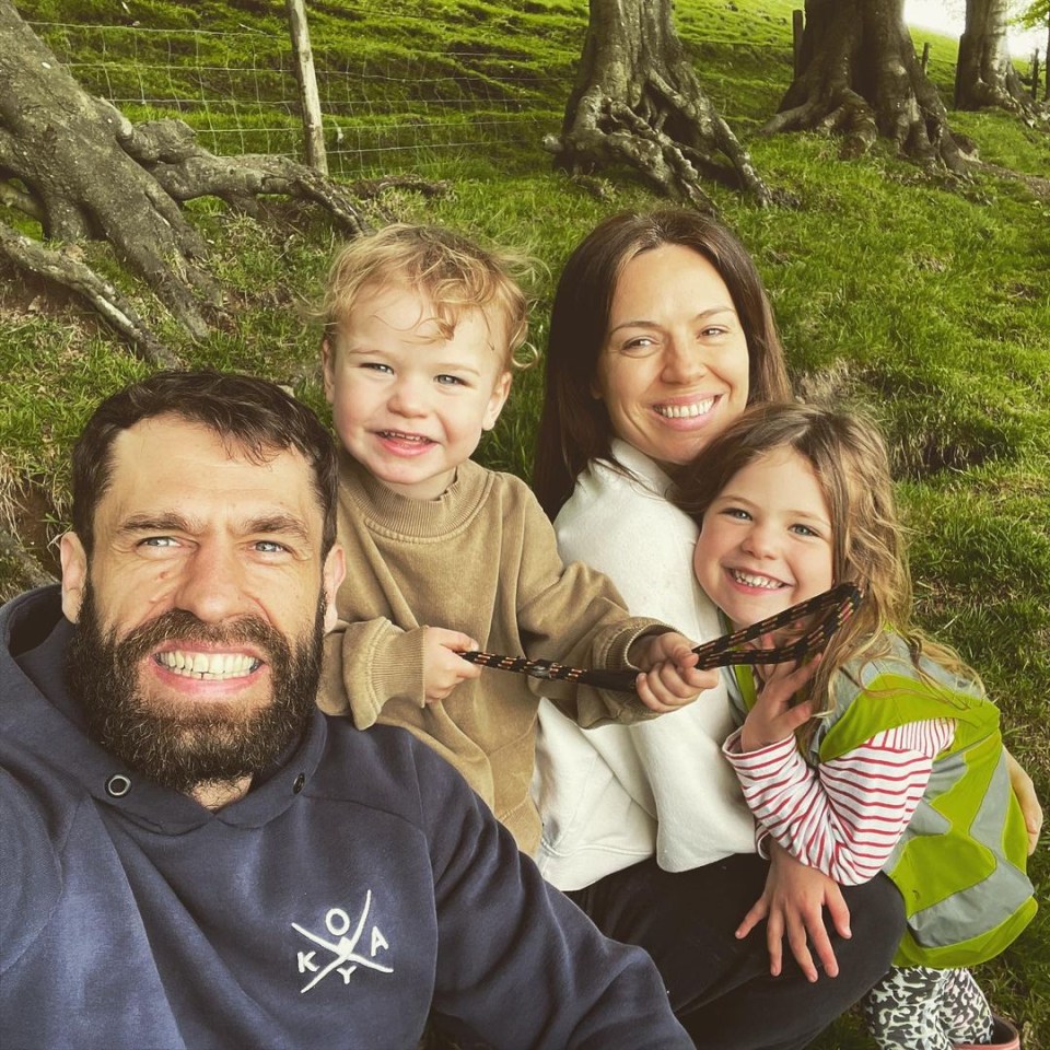 Kelvin Fletcher, his wife Liz Marsland, and their two children smiling for a selfie outdoors.