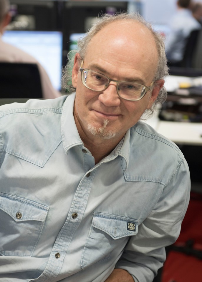 Man with glasses, goatee, and light blue shirt.