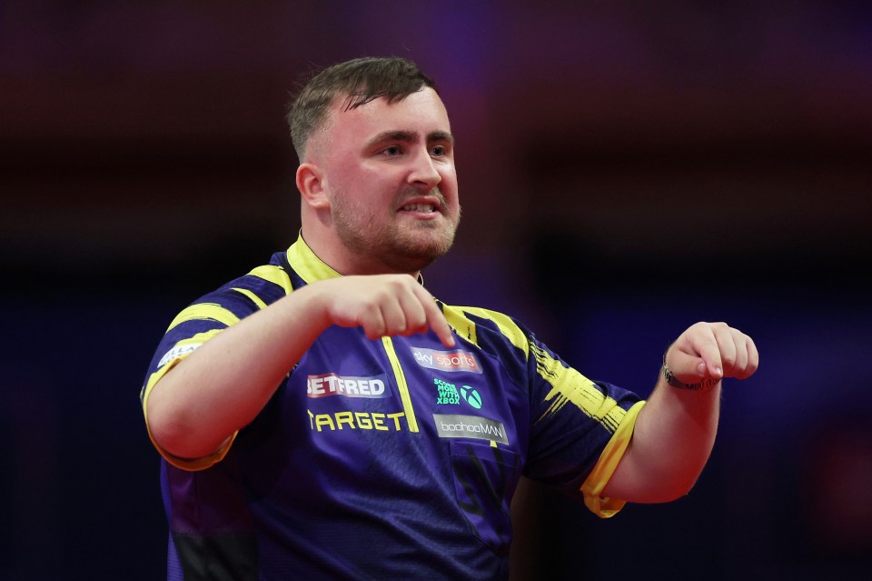 Luke Littler of England celebrating during a darts match.