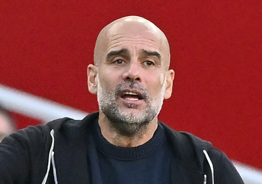 Manchester City's head coach Josep Guardiola gesturing during a soccer match.