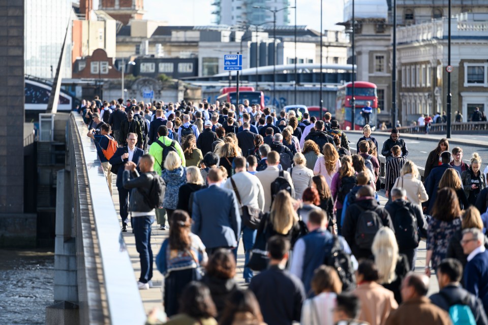 Large crowd of people commuting to work in London, England.