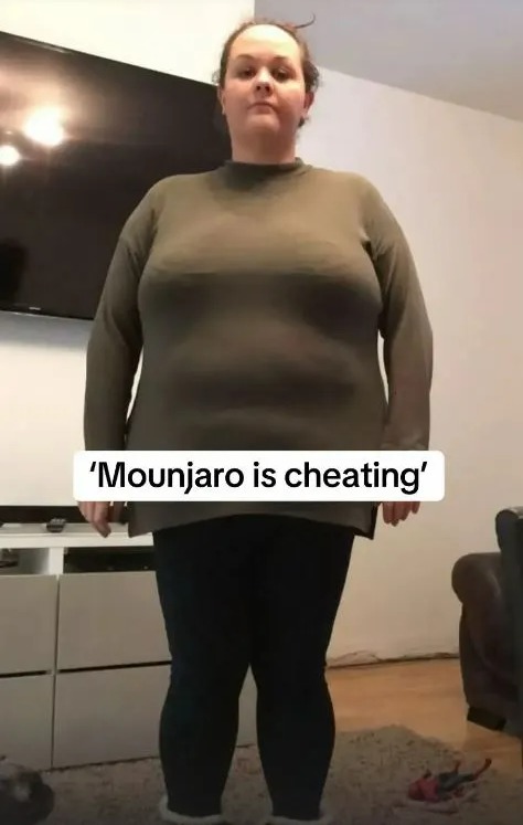 A woman in a gray shirt and dark leggings stands with text overlay that reads "'Mounjaro is cheating'".