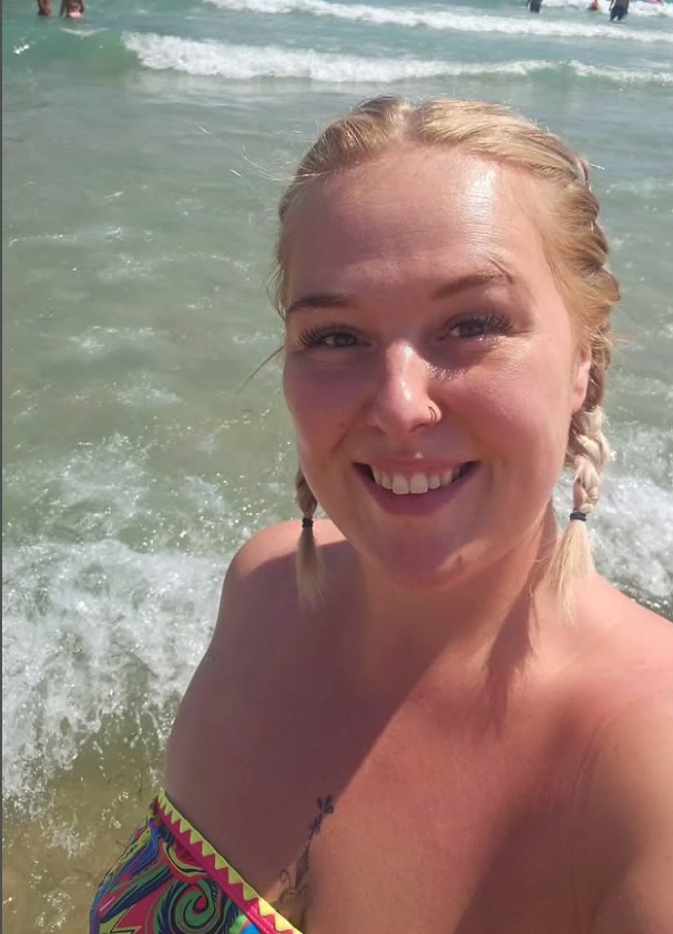Woman smiling at the beach.