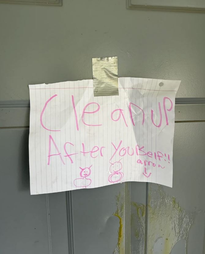 Note taped to a door that says "Clean up After Yourself!" with drawings of ants.