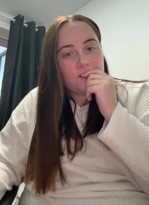 Woman in white sweater discussing weight loss.