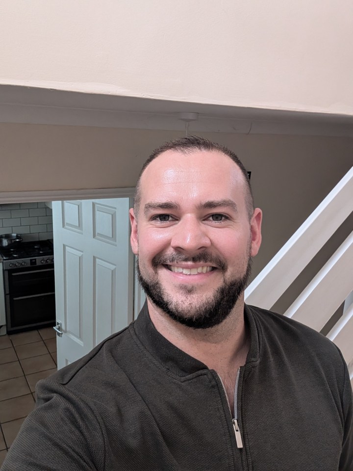 Photo of a smiling man.