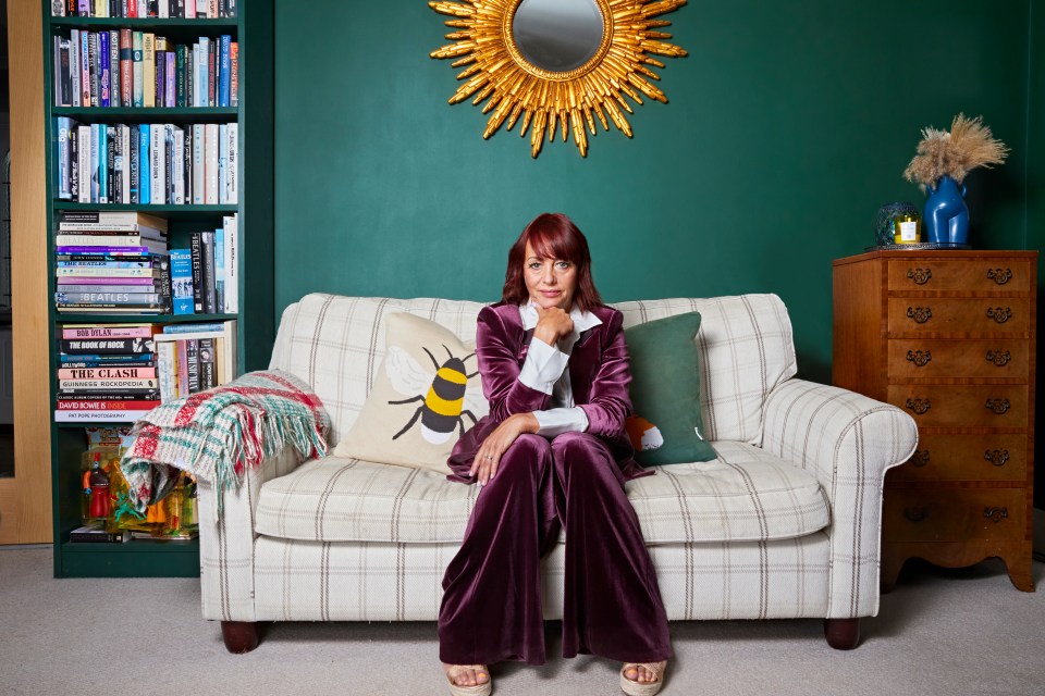 Portrait of a woman sitting on a sofa.
