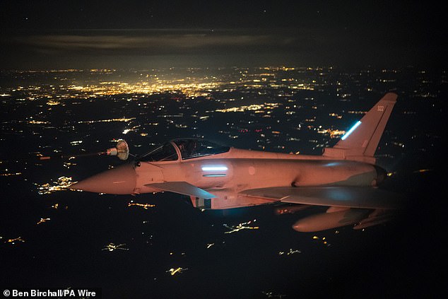 An Typhoon flies alongside an RAF Voyager tanker and transport plane to refuel at 25,000ft