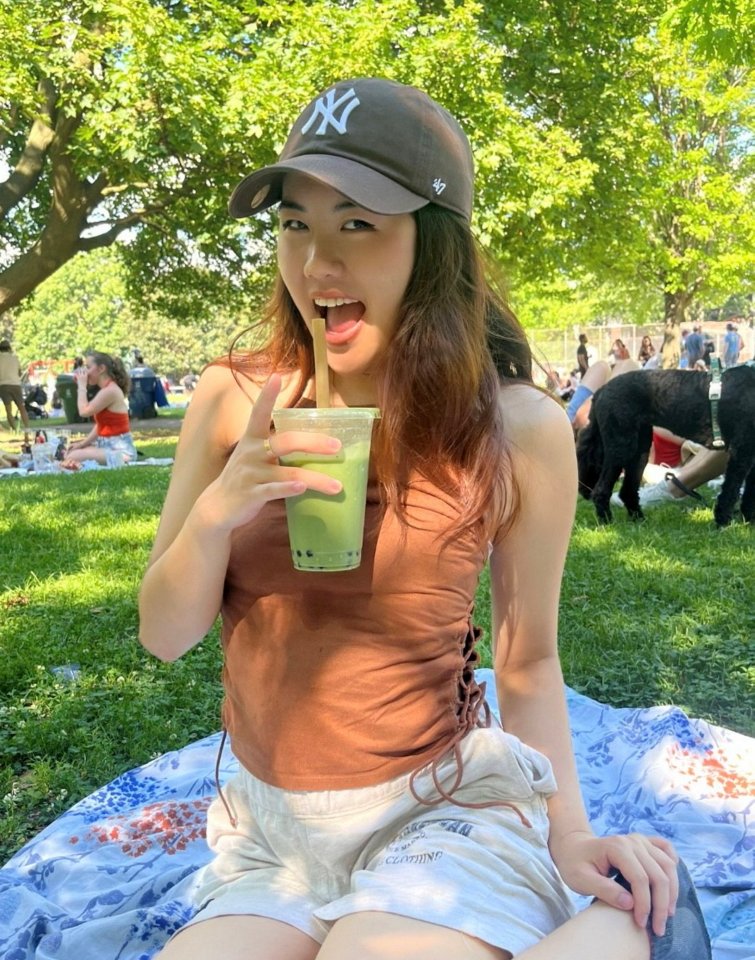 Young woman enjoying a matcha drink in a park.