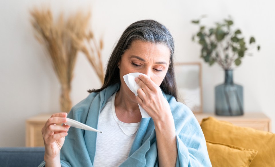 Sick woman checking her temperature.