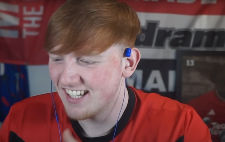 Angry Ginge laughing with blue earbuds.