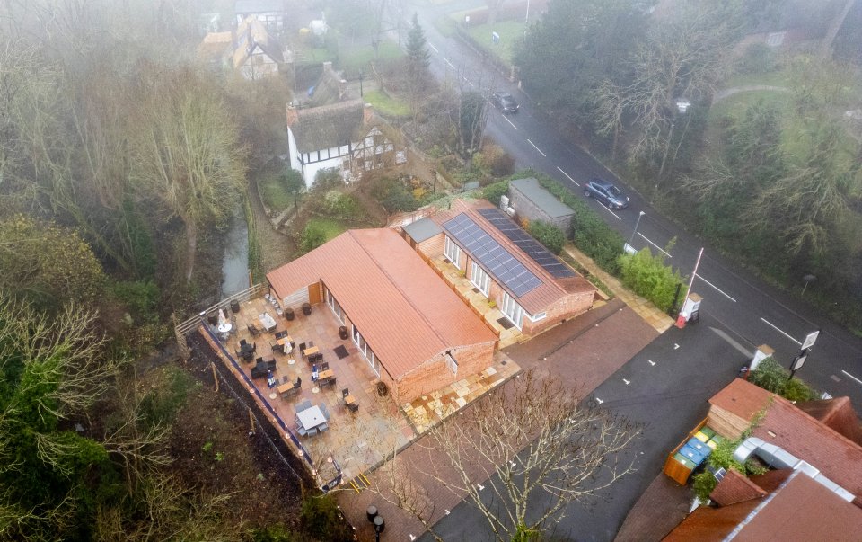 Aerial view of a gastro pub with solar panels on the roof.